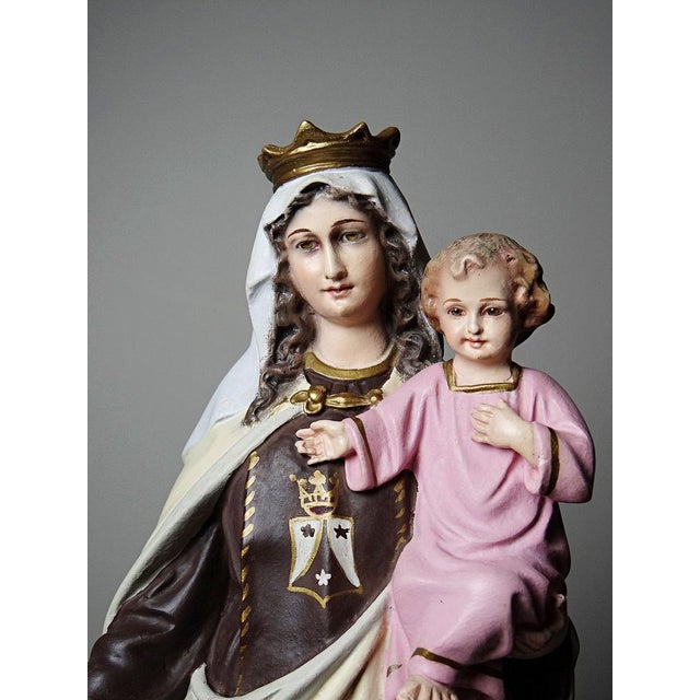 A rare and exquisitely hand-painted polychrome wooden and stucco religious statuette from the 1920s-1930s, depicting Our...