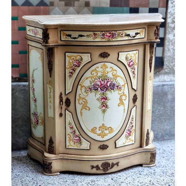 This charming French-style wooden cabinet features a soft, romantic color palette with beautifully hand-painted floral...