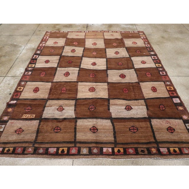 A vintage Turkish Anatolian tribal room size carpet handmade during the Mid-20th Century. Measures: 9' 1" x 11' 6".