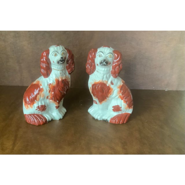 Classic white glaze with red-brown markings, black accents and yellow eyes
