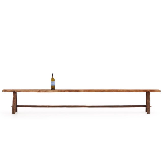 Each long rustic bench features a narrow, solid elm plank seat displaying an exceptional historic grain and rich warm...