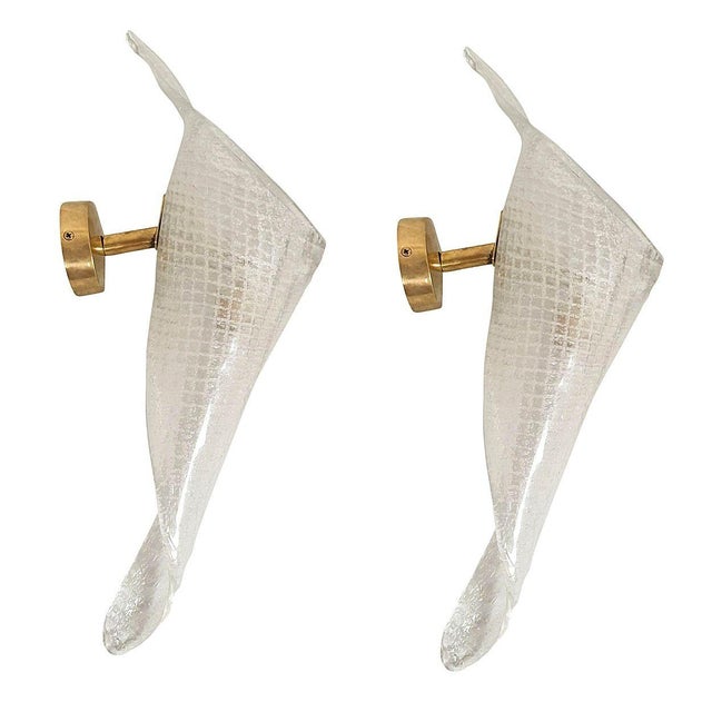 Pair of transparent handmade Murano glass sconces, attributed to Seguso, Italy 1970s. The Mid-Century sconces have brass...