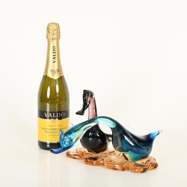 Magnificent Murano blown-glass sculpture depicting an elegant pair of swans. This delightful piece was produced in Italy...