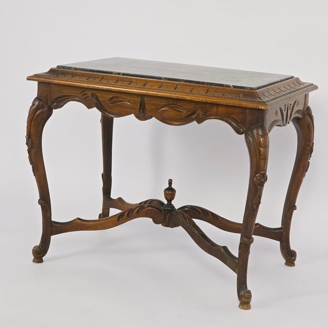 Antique French Edwardian/Victorian side table, combining elegantly scrolled cabriole legs and scrolled stretchers accented...