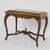 Antique French Edwardian/Victorian side table, combining elegantly scrolled cabriole legs and scrolled stretchers accented...