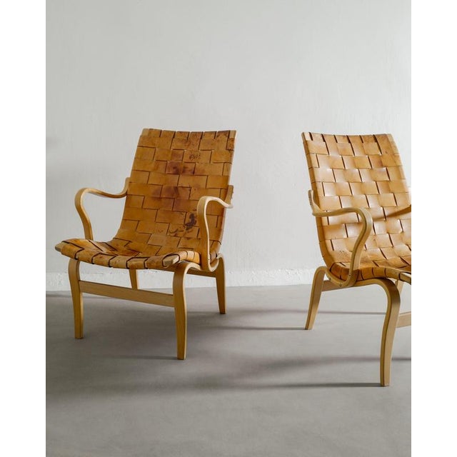 Rare pair of swedish modern "eva" sculptural armchairs in form pressed birch wood and patinated matching leather by bruno...
