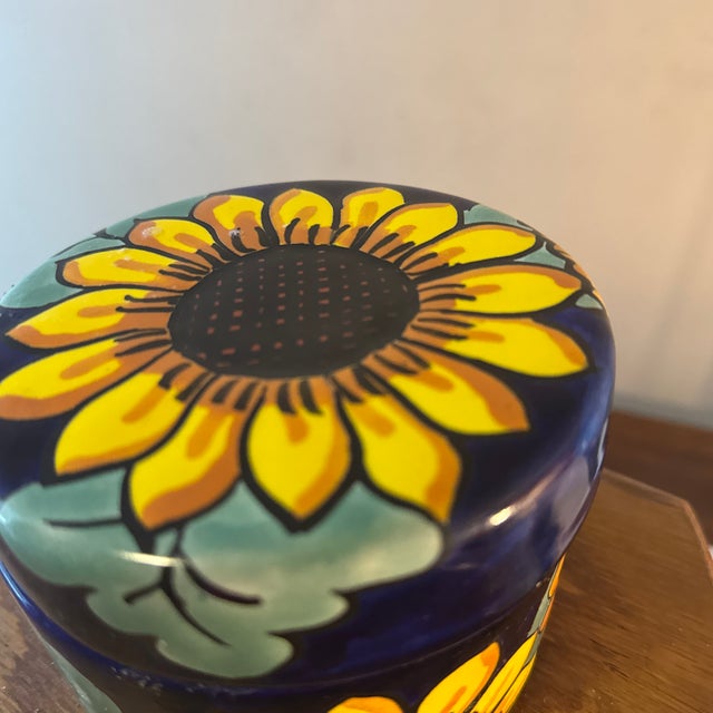 Brighten any space with this charming sunflower pottery trinket dish with lid. Handcrafted with care, its cheerful floral...