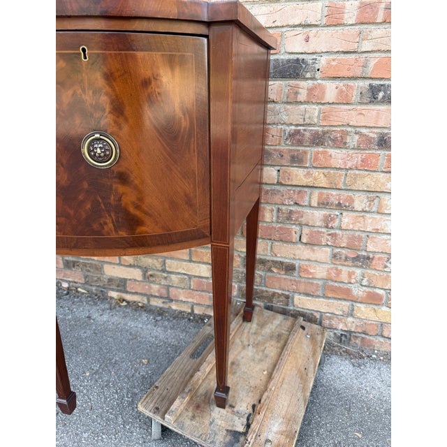 This is a 19th Century English sideboard. Its design was inspired by the hepplewhite sideboards from the Regency period...