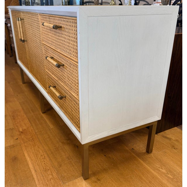 A coastal-luxury statement piece from Serena & Lily. Whitewashed oak frame with handwoven rattan cane fronts, rattan-...