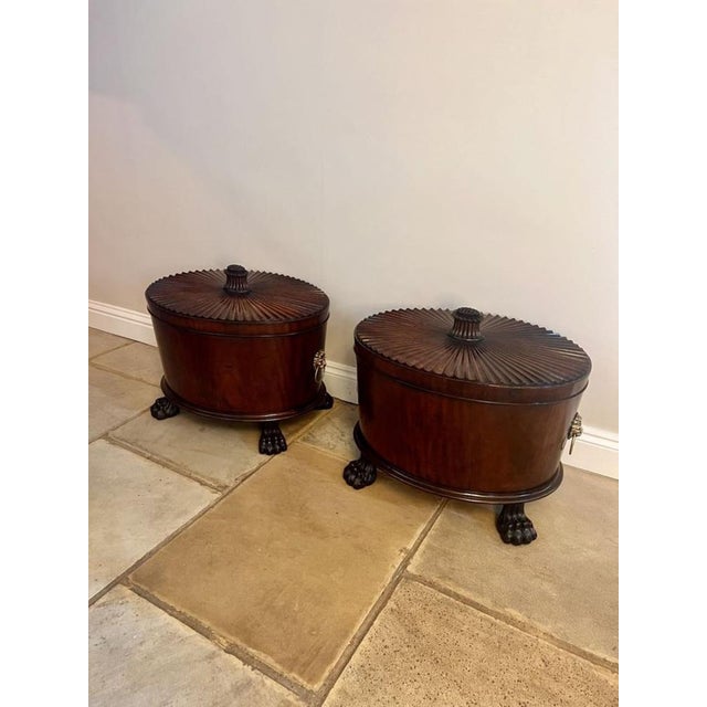 Unusual rare pair of antique George III quality mahogany wine coolers, having unusual oval shaped reeded tops with a...