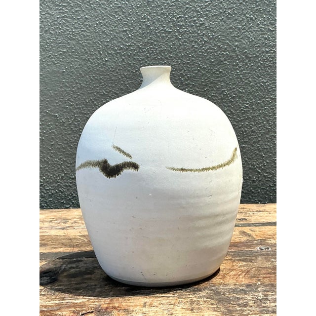 This sophisticated vintage Raku-fired studio pottery vase is a masterwork of Zen-inspired minimalism and organic form....