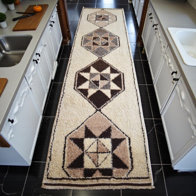 This hand-knotted runner from the 1980s is a testament to the rural weaving mastery of Southeastern Anatolia. Originally...