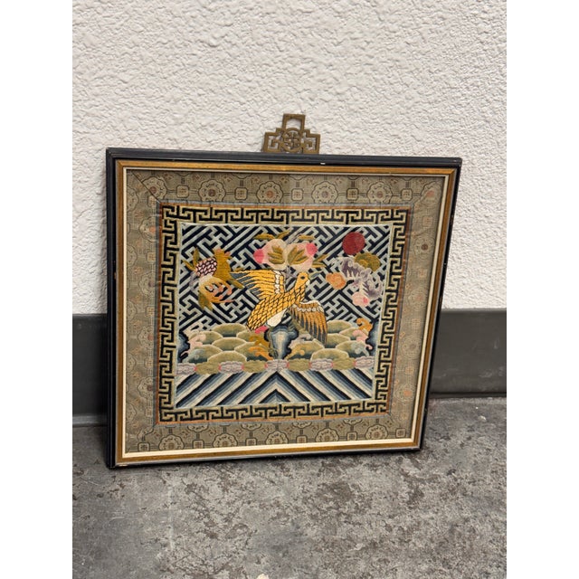 Design Plus Gallery presents a Fifth Rank Badge from the Qing Dynasty. The square embroidered panel has a golden peasant...
