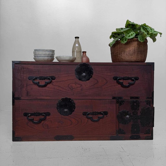 This antique Japanese kimono tansu dates from the late Meiji period, around c. 1910. The piece has a low, horizontal...