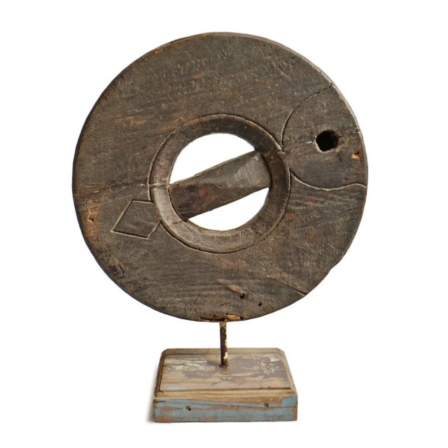 Antique wood grinder wheel from India on display stand. Great unique piece with character and history for display indoors...