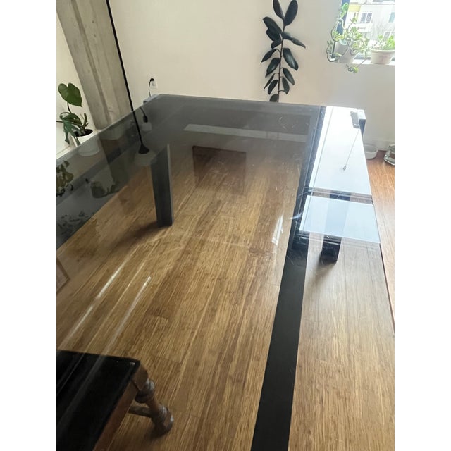 A beautifully crafted, handmade European dining table in solid wood with a deep, rich grey stain that highlights the...