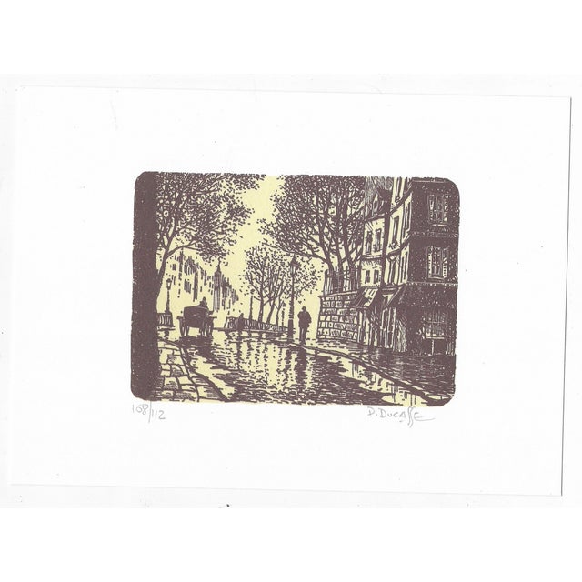 Color lithograph view of Paris and the Seine by mid century artist Paul Ducasse. Pencil signed and numbered 108 of 112....