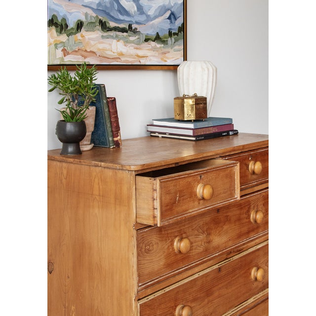 A charming antique pine chest of drawers, dating to the mid–late 19th century. Filled with character and a warm lived-in...