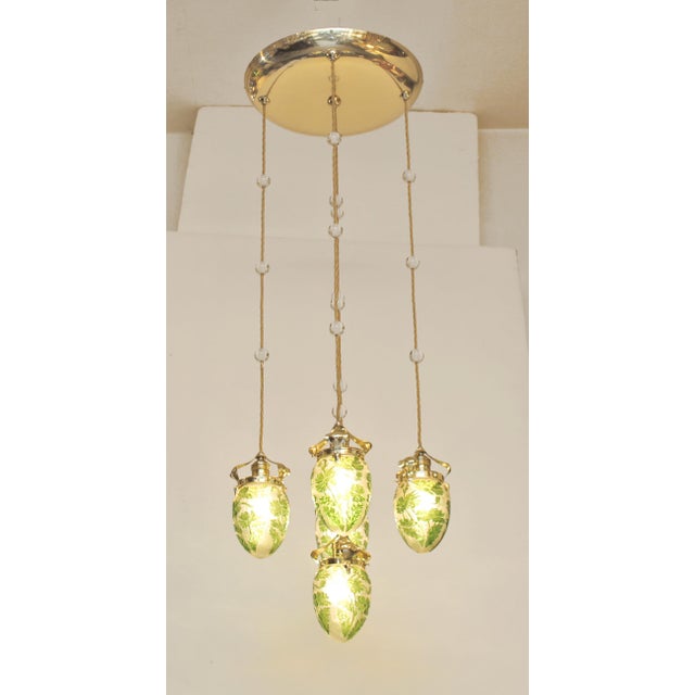Art Nouveau ceiling lamp, manufactured 1910/15. Large brass ceiling plate mounted on an inner wooden base. Five lights...