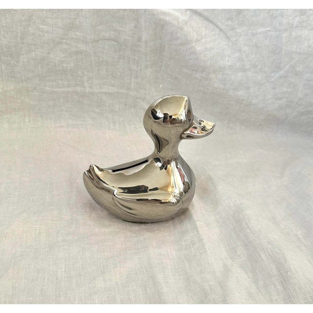 Super cute Silverplate Duck Piggy Bank, great for a kids room or just as decor in a office or bookshelf. The eyes are just...