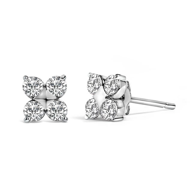 Immerse yourself in the wintry sparkle of these elegant stud earrings, meticulously crafted from 10K white gold and...