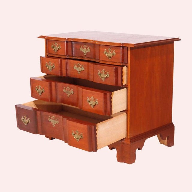 An English Chippendale style chest of drawers attributed to the Williamsburg Bartley Collection offers shaped top over...