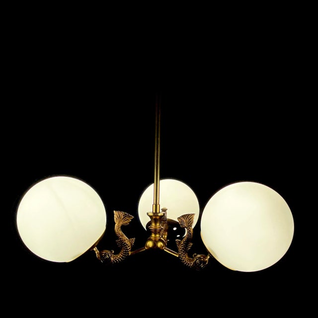 Superb set of French brass dolphin sconces and 3-arm chandelier with glass shades. Sourced in Provence, France. Features...