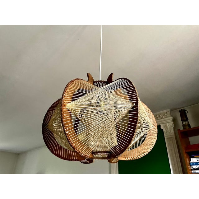 Scandinavian pendant light from the 1960s, lightweight wooden frame and beige tensioned wires. In very good vintage...