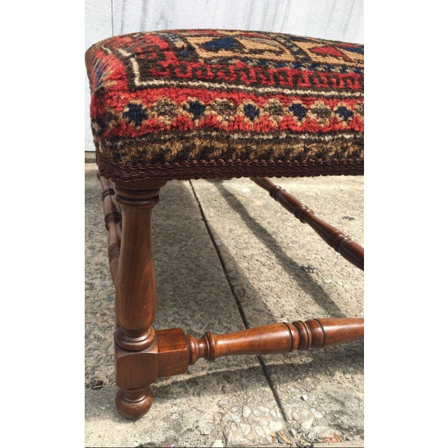 This handsome turned wooden bench is covered with a striking handwoven Balochistan prayer rug. Featuring a geometric...