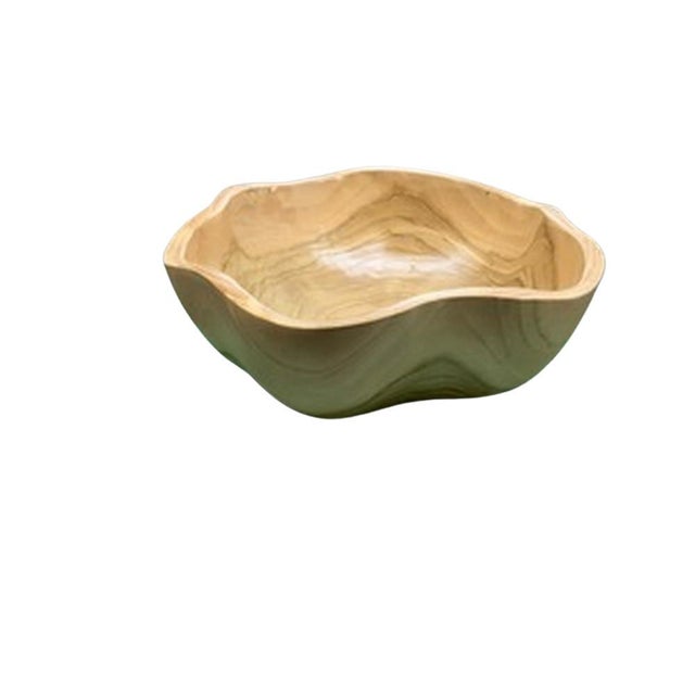 This teak live edge bowl is a unique piece showcasing the natural beauty of teak wood. Crafted by skilled artisans, its...