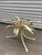 This vintage Italian coffee table features a distinctive bouquet of painted metal flowers and wheat stalks as its central...