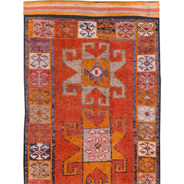This mid-20th-century Turkish Anatolian tribal runner presents a bold sequence of five large geometric medallions arranged...