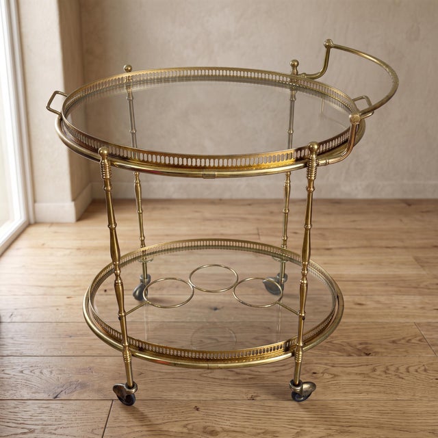 Prestigious two-tier bar cart in gilded brass and crystal, attributed by its lines and finishes to the neoclassical style...