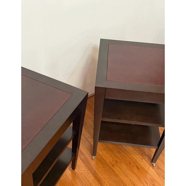 A sophisticated pair of unusually tall Paris occasional tables attributed to Donghia, featuring clean architectural lines,...