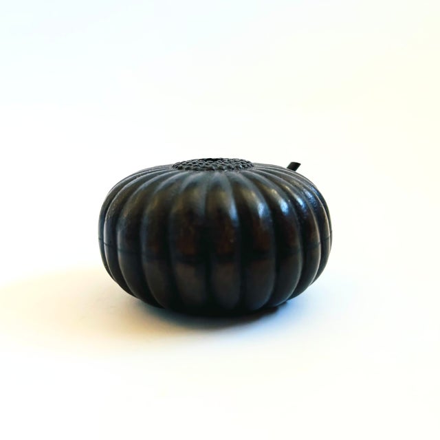 A vintage cast iron suiteki water dropper in the shape of a gourd. Traditionally used for calligraphy or ink painting....