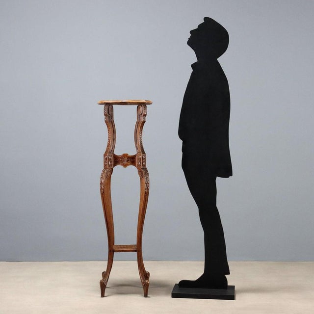 Late 19th-century walnut plant stand from Italy, featuring a molded upper surface supported by four cabriole legs, richly...