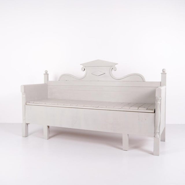 Antique storage bench from the 1860s in grey-painted pine wood with carved details and storage. Antique storage bench from...
