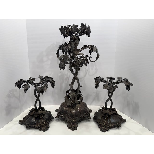 Stunning, highly detailed 3-piece silver-plated candelabra table garniture set from the late Victorian era. Executed...