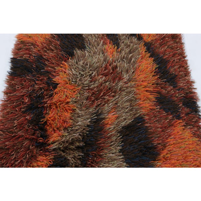 Hand-knotted in lush, high-pile wool in Sweden circa 1960-1970, this 2x4 vintage Swedish Rya runner rug is a bold new...