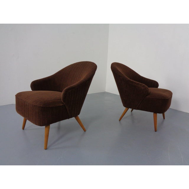 Pair of cocktail chairs from the 1960s. Original brown corduroy upholstery. Spring core cushions. The matching sofa is...