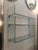 A set of three Mod. Babila wall shelves in curved glass with chrome-plated metal brackets, manufactured by Fiam Italia....