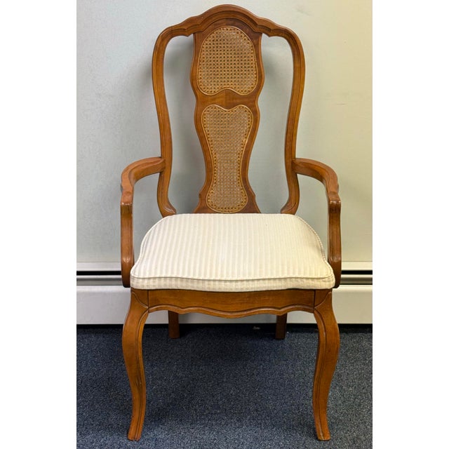 Elegant set of six vintage French Provincial–style dining chairs featuring beautifully shaped warm wood frames, graceful...