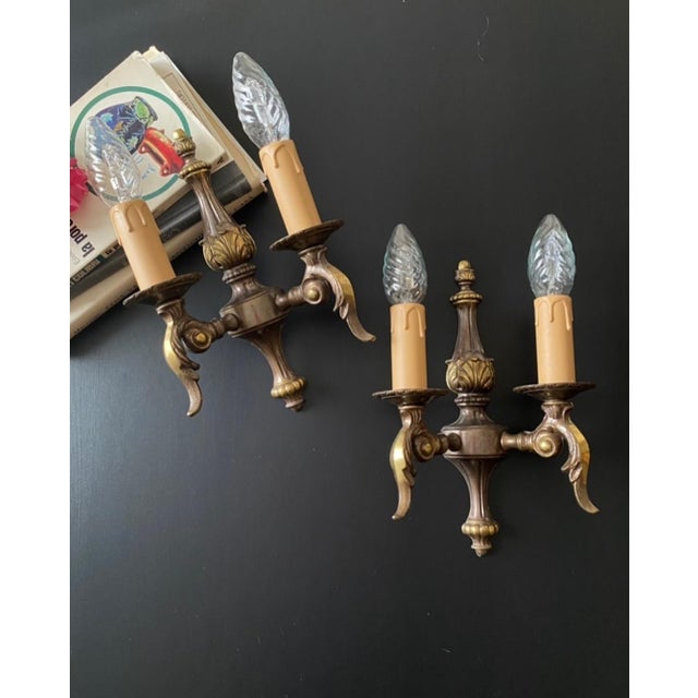 Antique paired sconces. Italy, twentieth century. The sconces are made of bronze and brass. Beautiful and exquisite...
