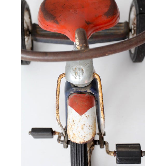 1950s Midwest Industries children's tricycle in a classic red, white, and blue color palette. The streamlined steel frame,...