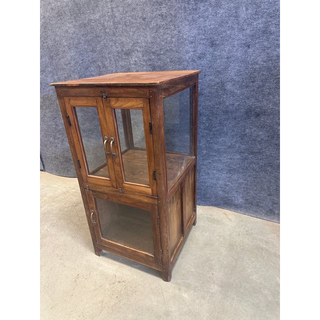Add a touch of rustic warmth and timeless character to your space with this charming vintage-style wood and glass curio...