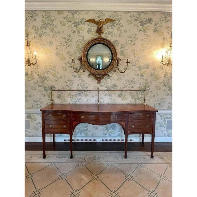 Offered is an exquisite antique 1790s English Georgian lll inlay mahogany serpentine sideboard with removable large brass...