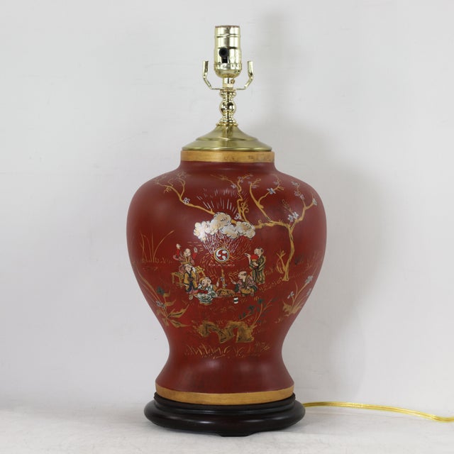 This pair of vintage table lamps features a classic ginger jar silhouette finished in a rich, deep red lacquer, providing...