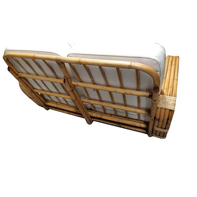 This rare, museum-quality four-strand square pretzel round-back settee was designed by Paul T. Frankl using the highest-...