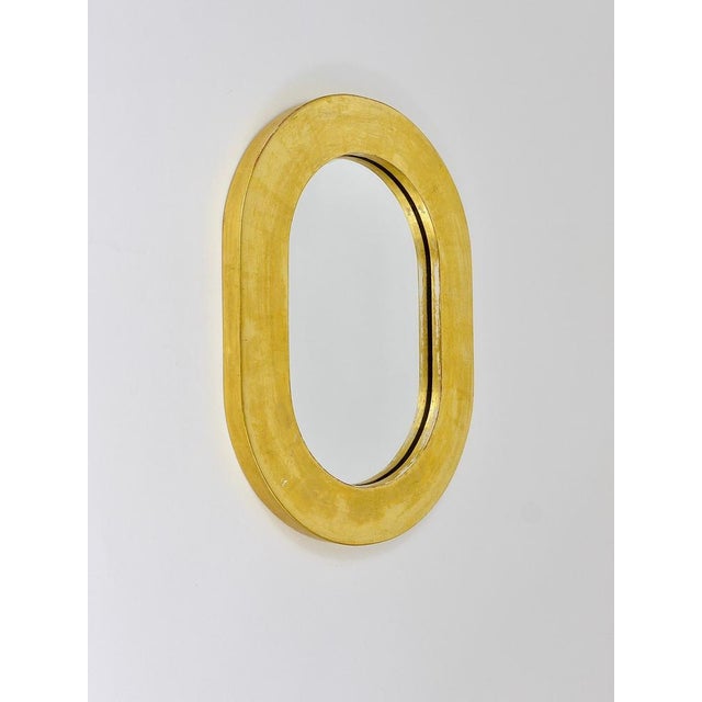 Beautiful Austrian modernist wall mirror. Designed and executed by Carl Aubock, Vienna/Austria. Made of gold-plated wood....