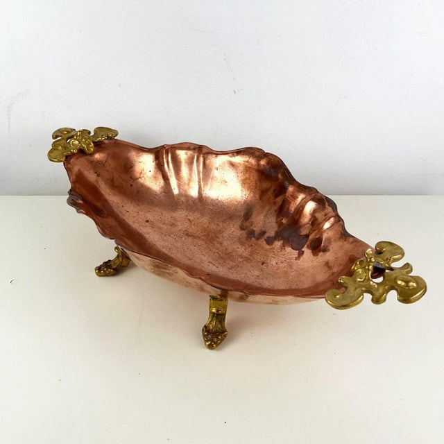 Transform your space with the timeless beauty of this antique Italian decorative footed copper dish. Adorned with...